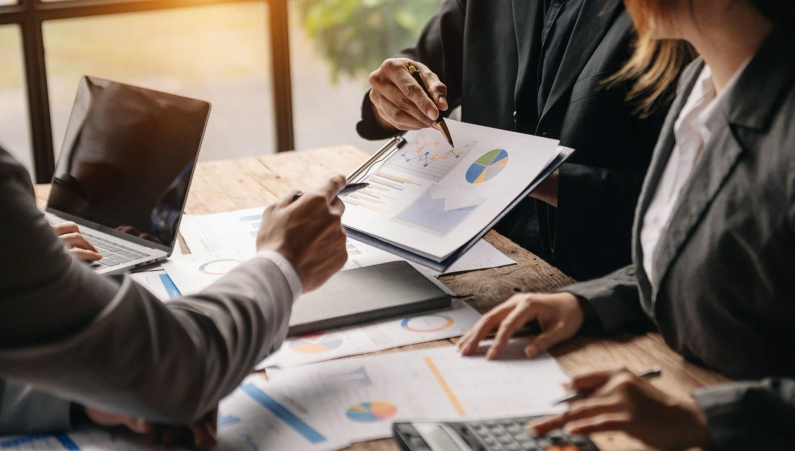 Advisors reviewing financial charts together — planning built around your goals